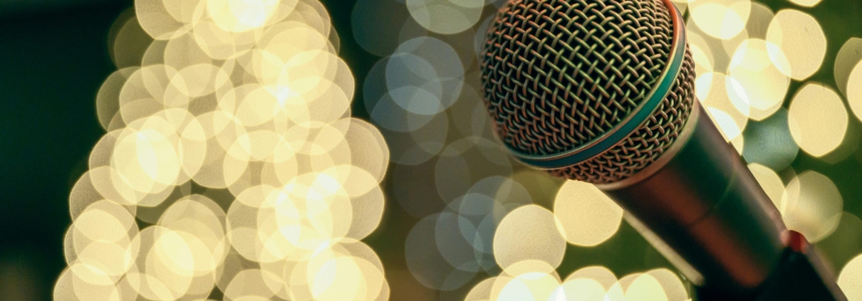 microphone with christmas trees lit up in the background