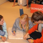 three children writing lyrics